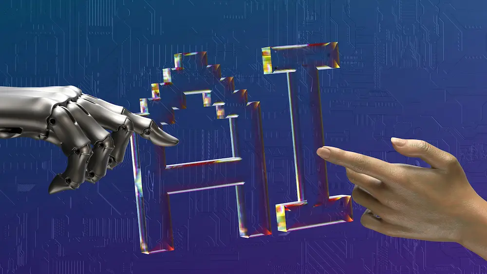 A robotic hand and a human hand reaching toward the letters AI on a blue circuit-board background