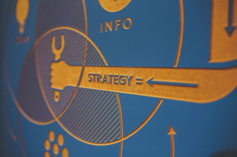 Close-up of a printed strategy diagram with the words INFO and STRATEGY